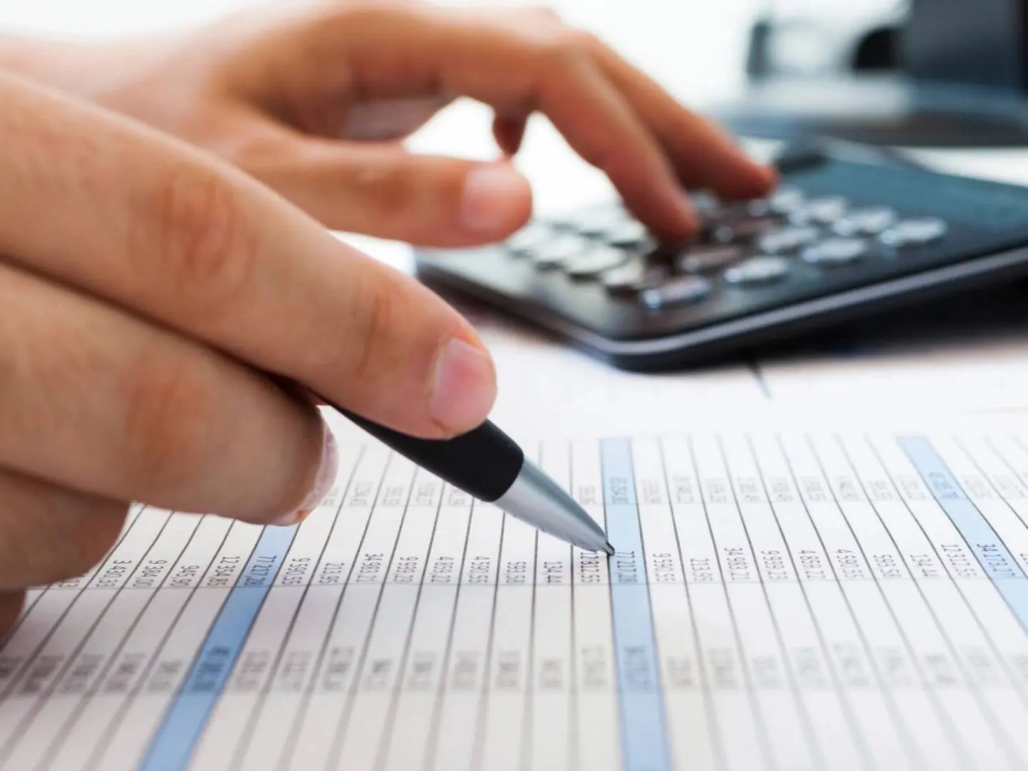 A picture of a person calculating all the prices