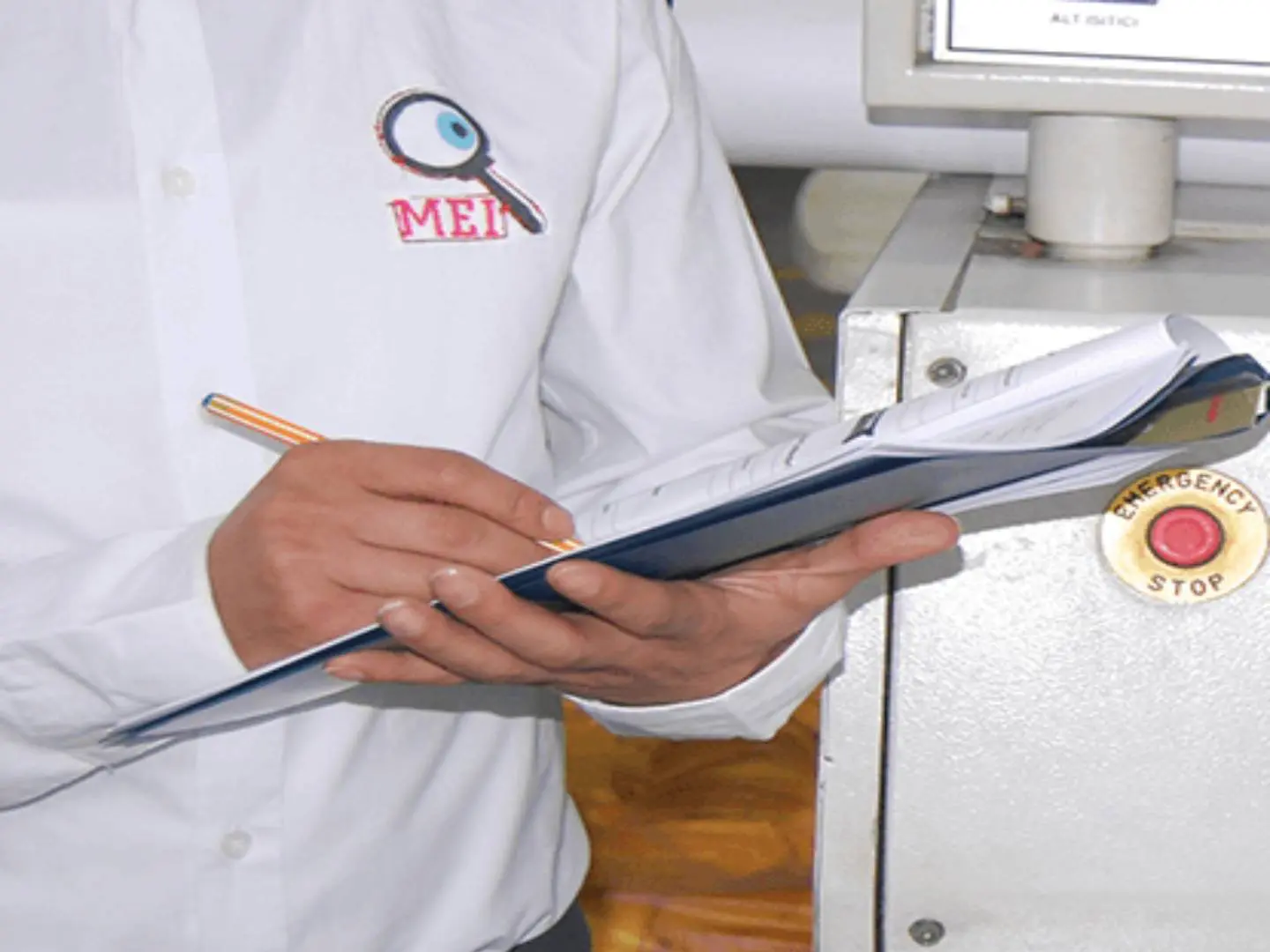 A picture of a person holding a file and writing on it